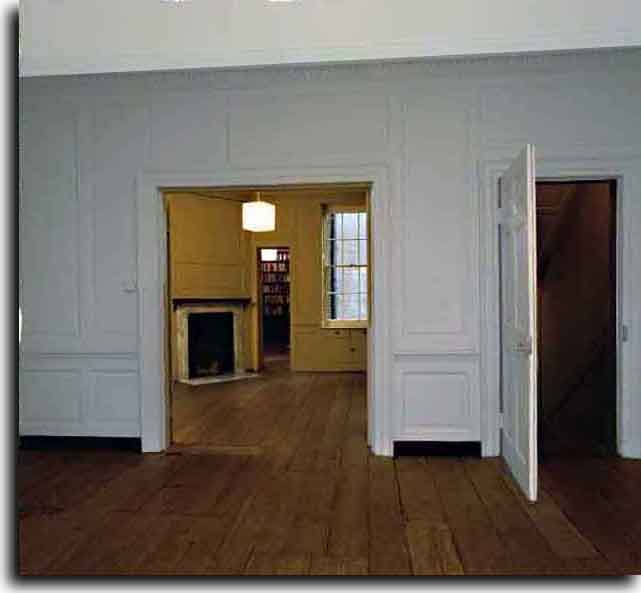 Front room view to middle room staircase, and closet in far distance